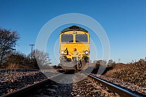 Front view of an approaching  freight locomotive on railway tracks