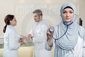 Front view of an arab doctor woman showing stethoscope.