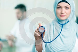 Front view of an arab doctor woman showing stethoscope.