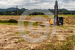 Front view of backhoe siting idle at construction site