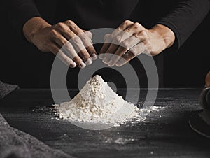 front view baker hands mixing flour. High quality photo