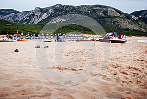 front view of bathhouse with mountains in the background in the early summer evening.