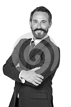 Front view of bearded smiling businessman in black formal suit posing with crossed hands. Waist up of elegant