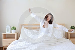 Front view beautiful and healthy young asian woman wake up in the morning, she stretching after wake up in the morning on white