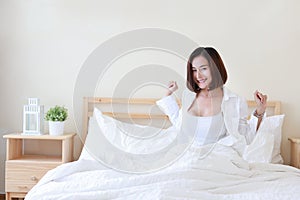 Front view beautiful and healthy young asian woman wake up in the morning, she stretching after wake up in the morning on white