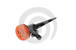 Front view of a black plastic garden sprinkler for irrigation with orange head and multiple water modes, isolated on white