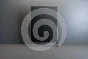 Front view on blank black banner with place for your text or logo in the center of empty room with glossy floor and dark grey wall
