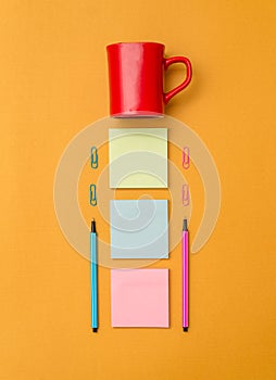 Front view blank sticky note two ballpoints pens clips coffee cup trendy pastel cool background. Empty text future