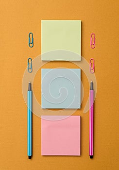 Front view blank sticky note two ballpoints pens clips trendy pastel cool background. Empty text future important events