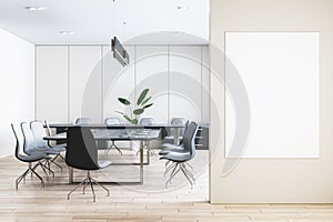 Front view of blank poster on beige wall and modern meeting room interior with office desk and chairs on background, mockup