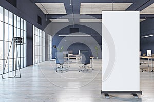Front view on blank white poster on concrete floor with place for your logo or advertising text on modern office background with