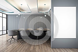 Front view on blank white poster on grey wall in stylish conference room with dark meeting table surrounded by chairs and city