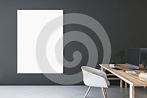Front view on blank white poster with space for your logo or text on dark wall background in stylish office with modern computer