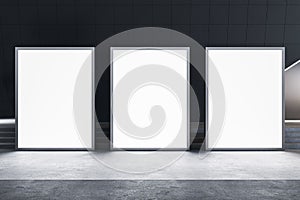 Front view on blank white three glowing advertising billboards with space for your logo or text on concrete floor in abstract