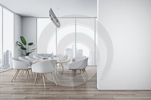 Front view on blank white wall with place for advertising poster in stylish sunlit meeting room with modern light furniture and