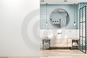 Front view on blank white wall in stylish blue shadow bathroom with round wooden mirror, modern light bulbs from top, wooden