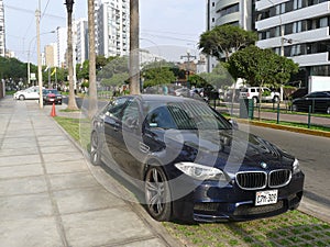 Front view of a blue color BMW M5 in Lima