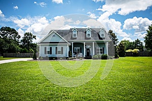 Front View of blue house with siding in the suburbs