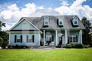 Front View of blue house with siding in the suburbs