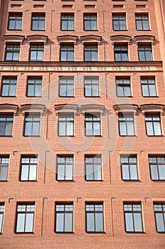 Front view of brick wall contemporary apartment building with windows