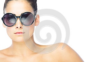 Front view of brunette woman wearing gigantic round sunglasses