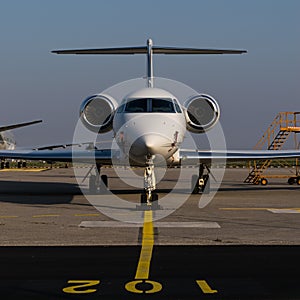 Front view of a business jet aircraft at a tarma