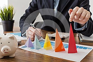 front view businessman with colorful cones representing growth. High quality beautiful photo concept