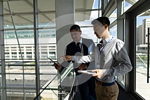 Front view of businessman interacting about digital tablet on the first floor of office