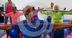 Front view of Caucasian female trainer training senior people in exercise at fitness studio 4k