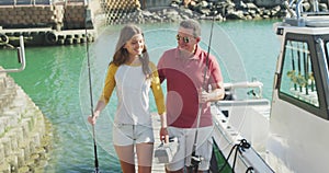 Front view of a Caucasian man and his teenage daughter go fishing