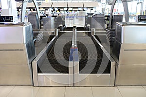 Front view of check-in area with baggage handling belt conveyor in airport