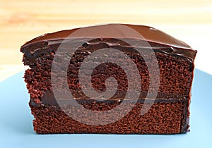 Front view of Chocolate Layer Cake Served on Wooden Table