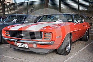 classic american sports car, first generation Chevrolet Camaro 350 Rally Sport in red orange color