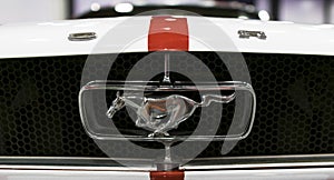 Front view of Classic retro Ford Mustang GT. Ford Mustang logo with running horse. Car exterior details.