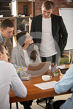 Front view colleagues working together in a office using modern devices and gadgets during creative meeting