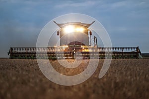 Front view of a combine harvester in the evening