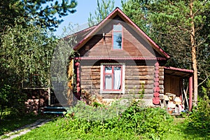 Front view of country log house on summer day