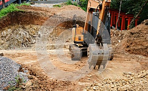 Front view of a crawler excavator at a construction site. Digging the pit foundation