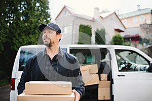 Front view of delivery man courier delivering parcel box in town.