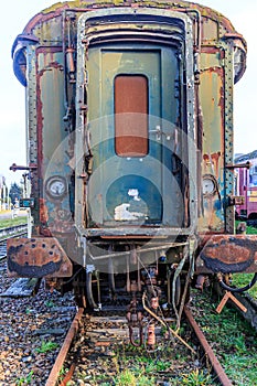 Front view of door of a passenger carriage on disused train tracks at old station