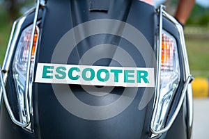 Front view of electric scooter with escooter sign board - concept of green energy, zero emission and transportation photo