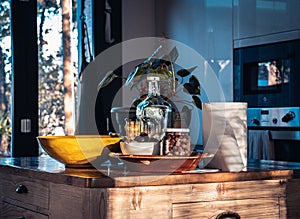 Front view of elegant interior with wooden kitchen table. Full wooden table and kitchenware in room.