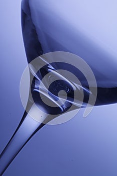 Front view of empty wine glass, on blue background