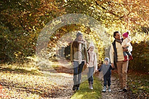 Front View Of Family Enjoying Autumn Walk In Countryside