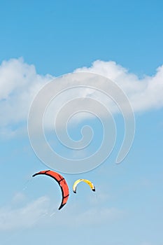 Orange canopy, filled with wind power, to propel a kite board photo