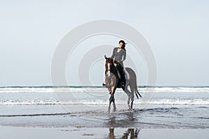 front view of female equestrian riding horse