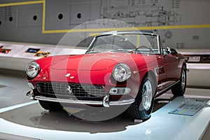 Front view of Ferrari 275 GTS red convertible sports car in Museum Enzo Ferrari Modena