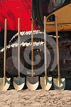 Front view of five shovels to be used in a ground breaking ceremony for a tropical, public park