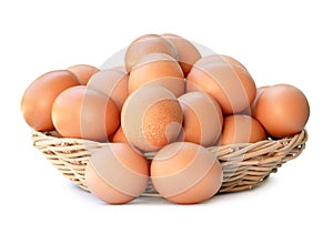 Front view of fresh brown chicken eggs in stack in woven bamboo basket isolated on white background with clipping path