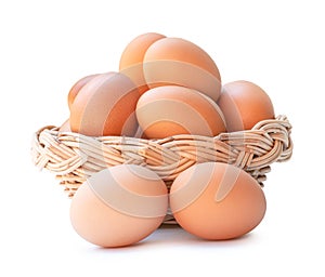 Front view of fresh brown chicken eggs in stack in woven bamboo basket isolated on white background with clipping path